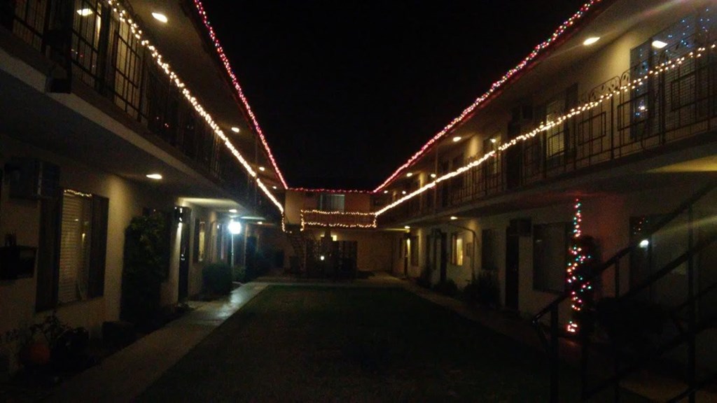 the corridor is lit up with christmas lights at night